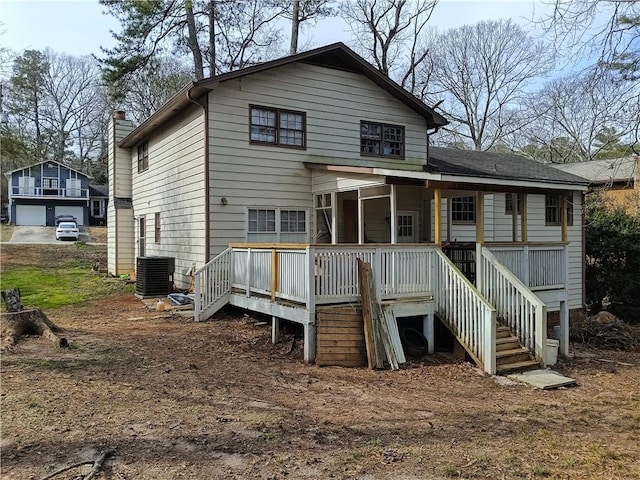 rear view of property with stairs, a chimney, a wooden deck, and central air condition unit