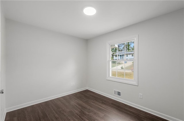 spare room with dark hardwood / wood-style flooring