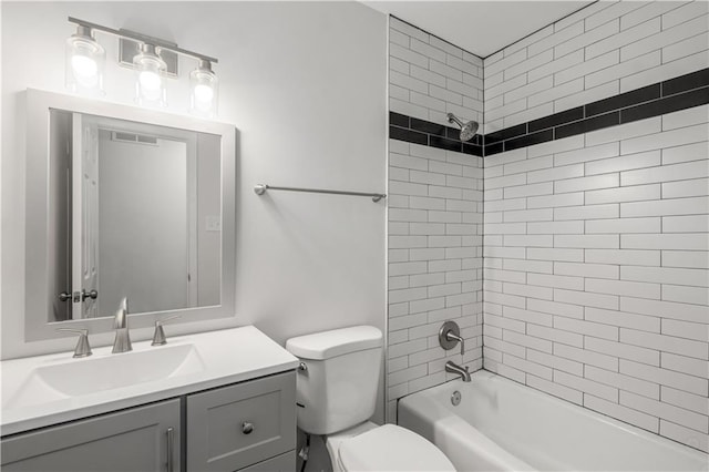 full bathroom with vanity, toilet, and tiled shower / bath