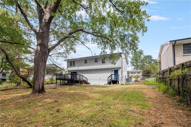 rear view of house featuring a lawn