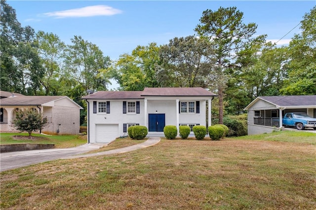 bi-level home featuring a garage and a front lawn