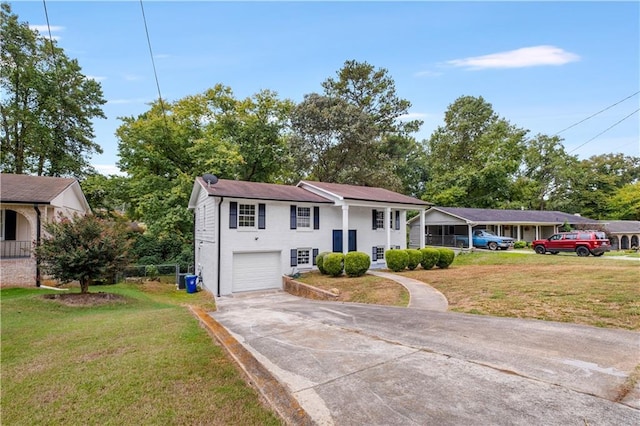 view of front of property featuring a garage and a front lawn