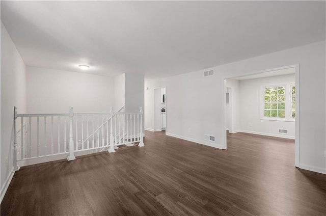 empty room with dark wood-type flooring