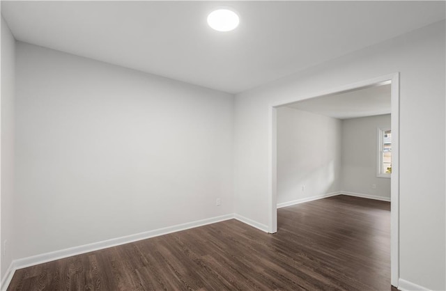 empty room featuring dark hardwood / wood-style flooring