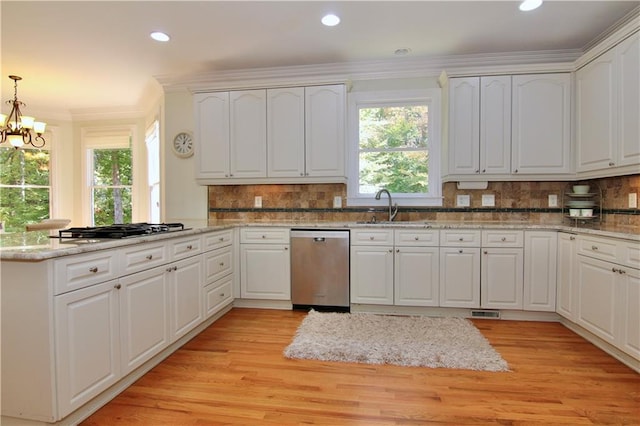 kitchen featuring decorative backsplash, appliances with stainless steel finishes, white cabinetry, light wood-type flooring, and pendant lighting