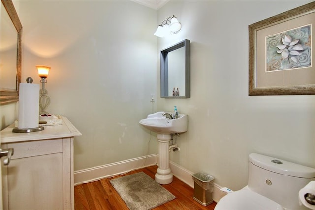 bathroom with toilet and wood-type flooring