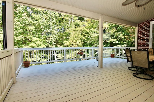 wooden terrace featuring ceiling fan