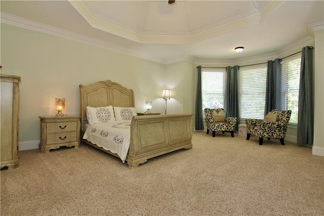 carpeted bedroom with ornamental molding and a raised ceiling