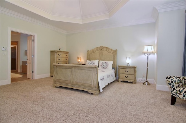 bedroom featuring connected bathroom, ornamental molding, a tray ceiling, and light colored carpet