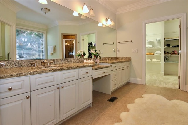 bathroom with vanity, crown molding, a shower with shower door, and tile patterned floors