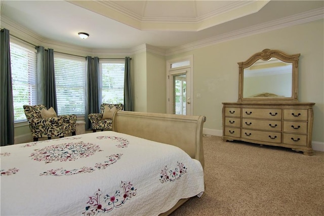 bedroom with light carpet, ornamental molding, and a tray ceiling