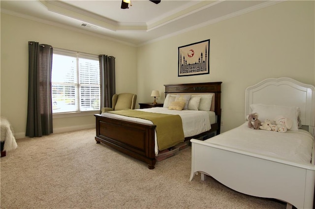 carpeted bedroom featuring ornamental molding, a raised ceiling, and ceiling fan