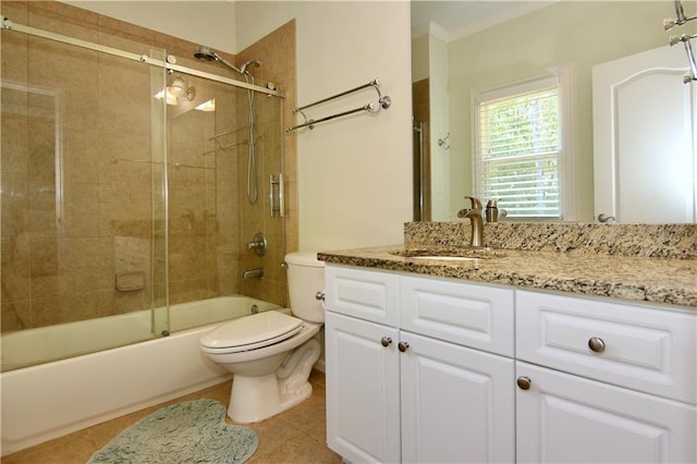 full bathroom featuring toilet, tile patterned flooring, ornamental molding, vanity, and enclosed tub / shower combo