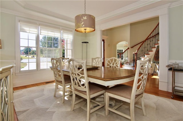 dining room featuring ornamental molding and hardwood / wood-style flooring