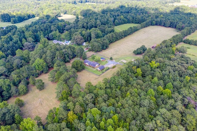 birds eye view of property featuring a rural view and a wooded view