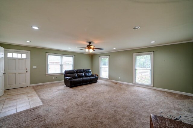 living area with baseboards, ornamental molding, recessed lighting, and light colored carpet