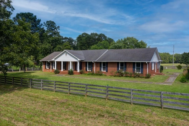 ranch-style house featuring a fenced front yard, a front lawn, and brick siding