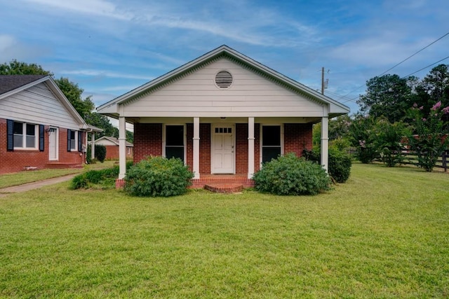 bungalow-style house featuring brick siding and a front lawn