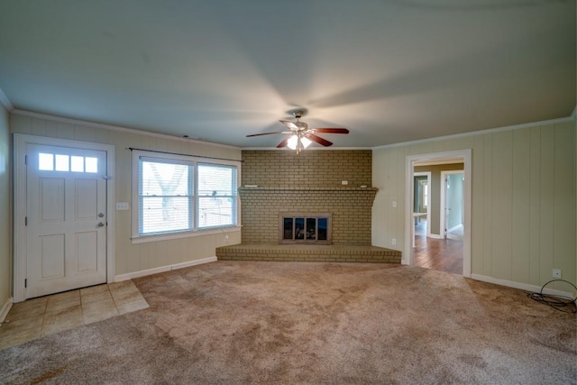 unfurnished living room with crown molding, a brick fireplace, and light colored carpet