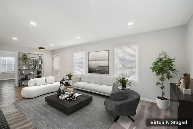 living room featuring recessed lighting, wood finished floors, and baseboards