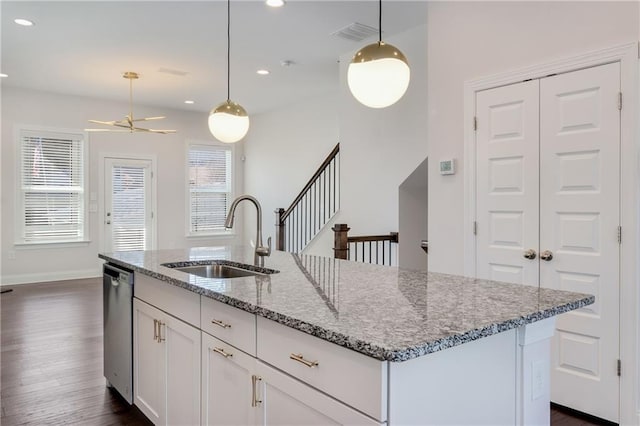 kitchen with dark wood finished floors, white cabinetry, a sink, an island with sink, and dishwasher