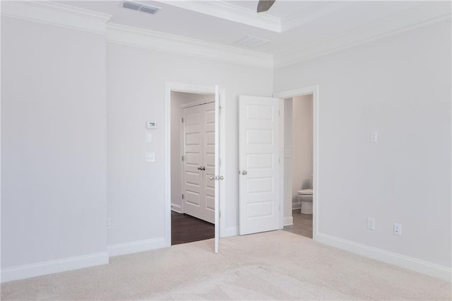 unfurnished bedroom featuring ornamental molding, carpet, visible vents, and baseboards