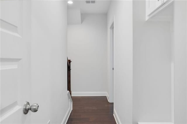 stairs featuring visible vents, baseboards, and wood finished floors