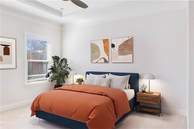 carpeted bedroom with a ceiling fan, a raised ceiling, crown molding, and baseboards