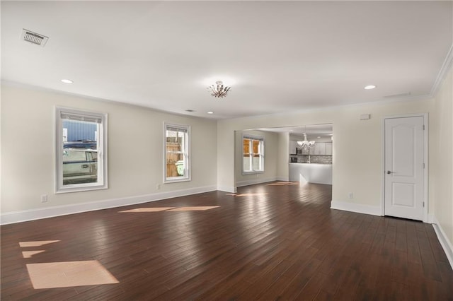 spare room with a notable chandelier, recessed lighting, visible vents, baseboards, and hardwood / wood-style flooring