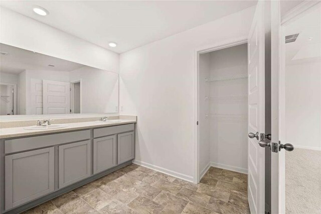 1410 Aura Ln, Lawrenceville, GA 30045 - full bathroom with double vanity, baseboards, a spacious closet, and recessed lighting