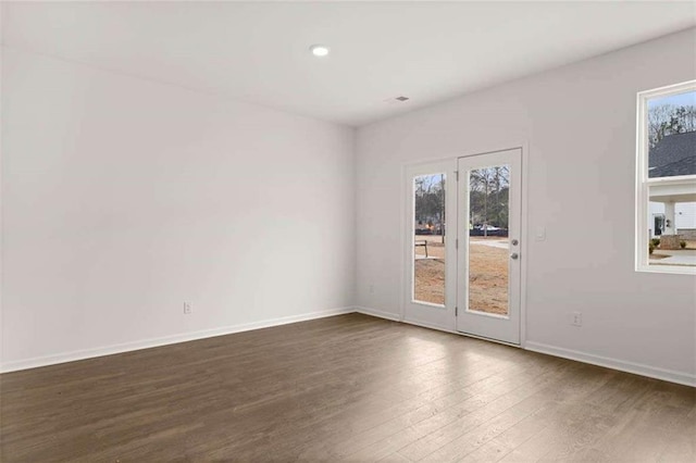 1410 Aura Ln, Lawrenceville, GA 30045 - spare room featuring dark wood finished floors, healthy amount of natural light, baseboards, and recessed lighting