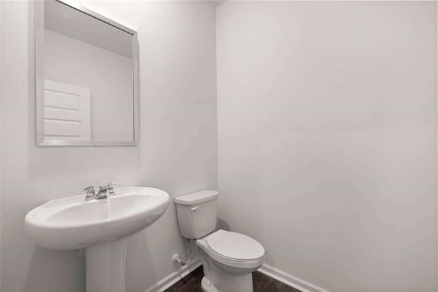 1410 Aura Ln, Lawrenceville, GA 30045 - bathroom featuring toilet, wood finished floors, and baseboards