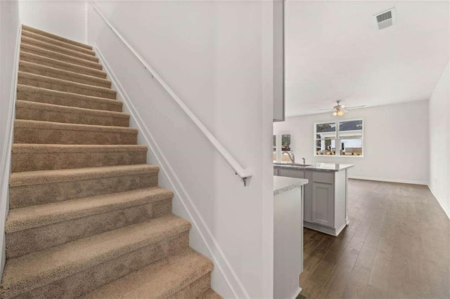 1410 Aura Ln, Lawrenceville, GA 30045 - stairway featuring wood-type flooring, ceiling fan, and baseboards
