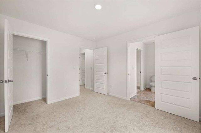 1410 Aura Ln, Lawrenceville, GA 30045 - unfurnished bedroom with carpet floors, a closet, baseboards, and ensuite bathroom