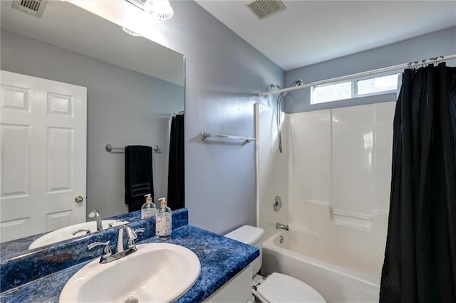 full bath featuring toilet, visible vents, vanity, and shower / bathtub combination with curtain
