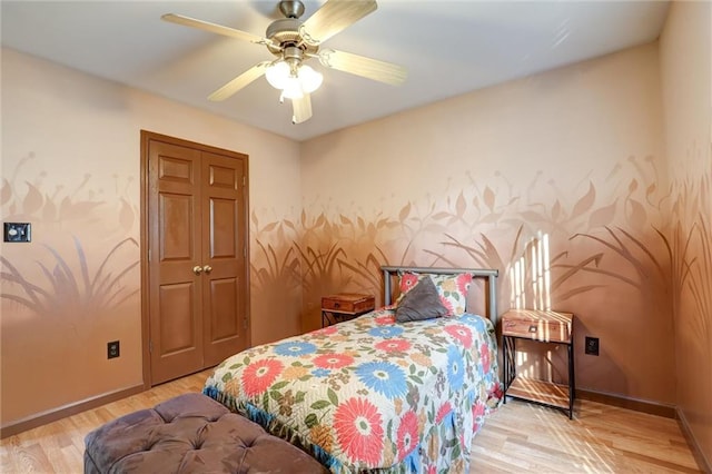bedroom with baseboards, a ceiling fan, and wood finished floors