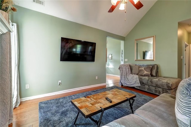 living room featuring wood finished floors, high vaulted ceiling, visible vents, baseboards, and ceiling fan