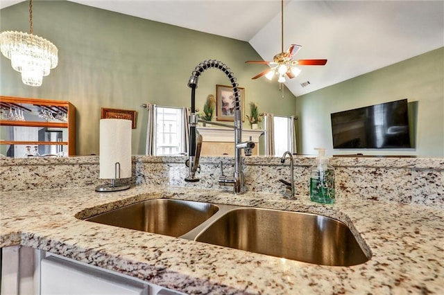 room details with a sink, ceiling fan with notable chandelier, and visible vents