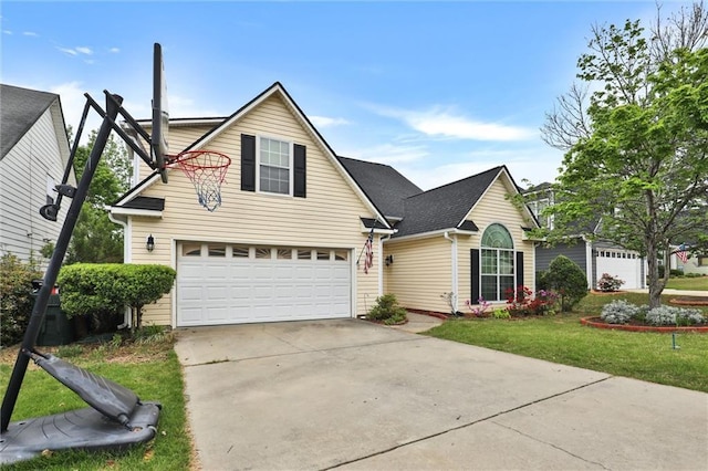 traditional-style house with an attached garage, concrete driveway, and a front yard
