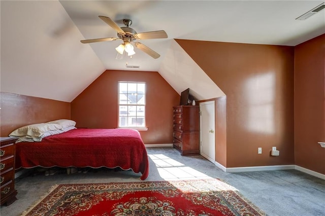 carpeted bedroom with vaulted ceiling, baseboards, and visible vents
