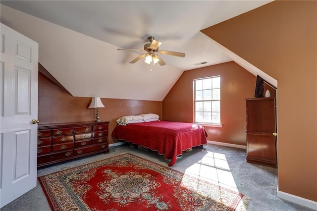 carpeted bedroom with vaulted ceiling, visible vents, baseboards, and a ceiling fan