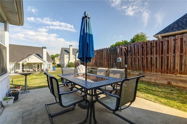 view of patio with outdoor dining area and fence