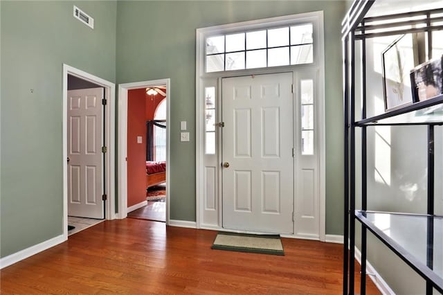 foyer featuring a healthy amount of sunlight, visible vents, and wood finished floors