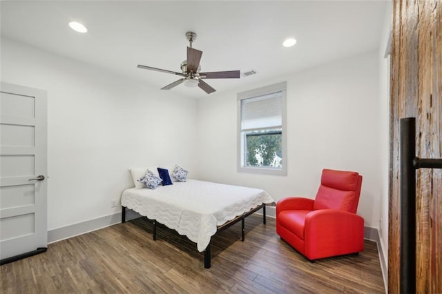 bedroom with dark hardwood / wood-style floors and ceiling fan