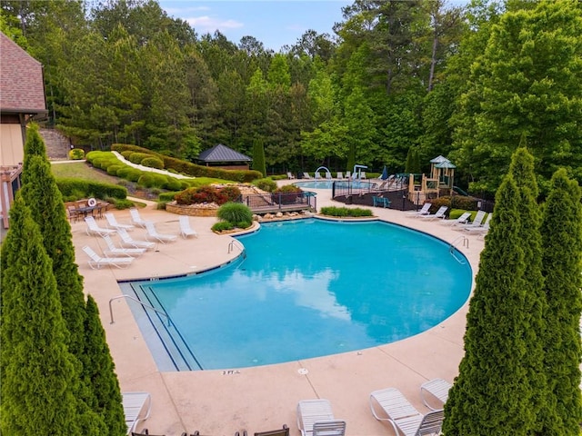 36 Evergreen Way, Dallas, GA 30157 - community pool featuring a patio and a forest view