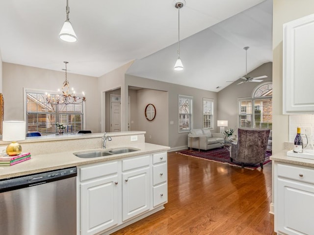 kitchen featuring hanging light fixtures, stainless steel dishwasher, sink, white cabinets, and light hardwood / wood-style flooring