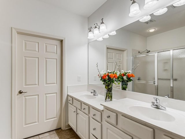 bathroom featuring tile patterned floors, walk in shower, and vanity