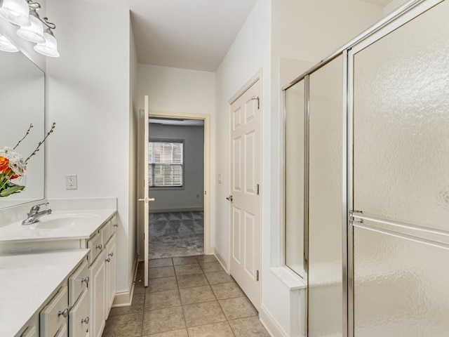 bathroom with walk in shower, tile patterned floors, and vanity