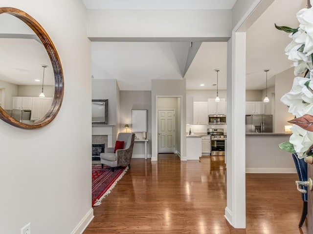 entryway with a tile fireplace and hardwood / wood-style floors