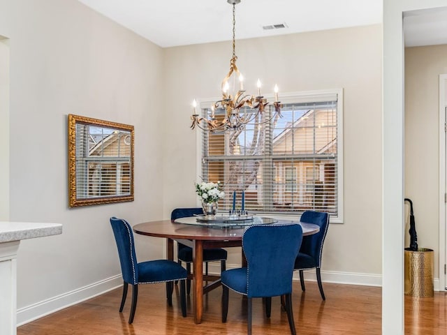 dining room featuring hardwood / wood-style flooring and a notable chandelier